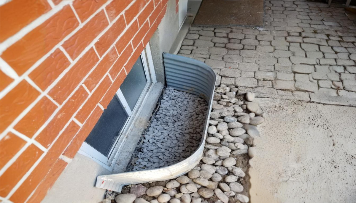 Grading the soil to direct water away from the foundation